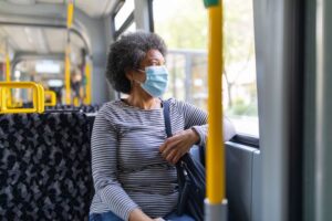 A person on a bus wearing a mask